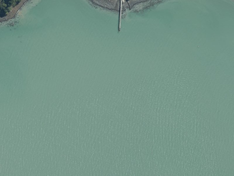 aerial view of Rāpaki Bay and the ground around it