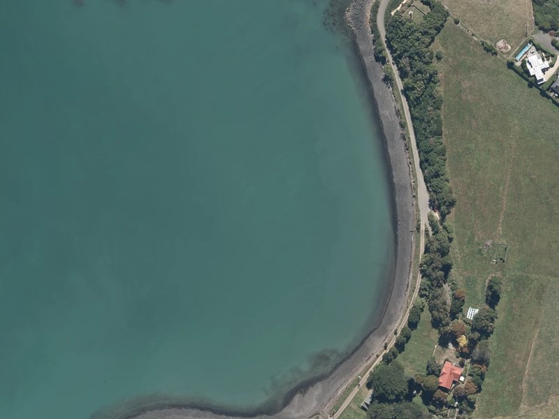 aerial view of Takapūneke / Red House Bay and the ground around it