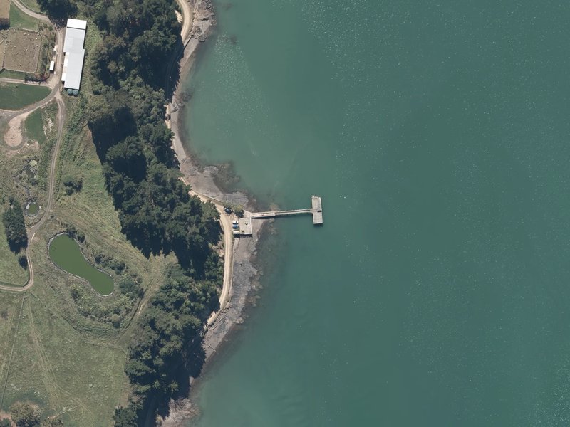 aerial view of Duvauchelle Wharf and the ground around it