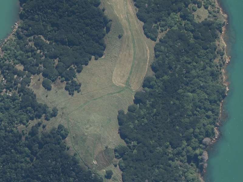 aerial view of Ōnawe and the ground around it