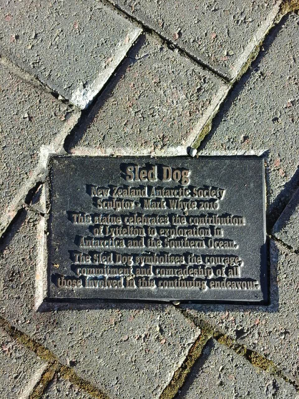 the register’s photograph of the plaque at Sled Dog