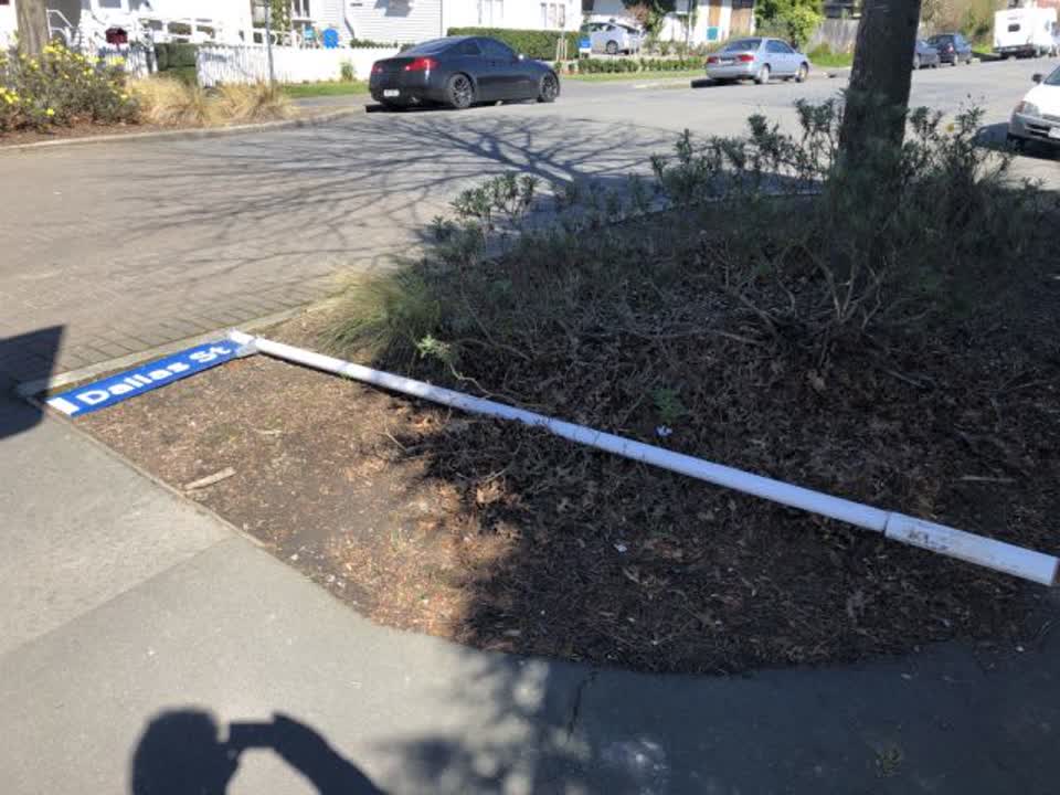 The photograph attached to this damaged street sign report