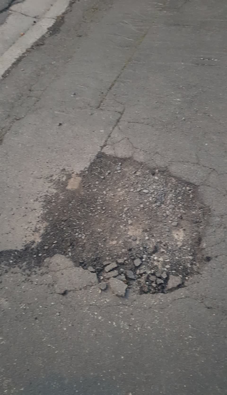 The photograph attached to this pavement - damaged report