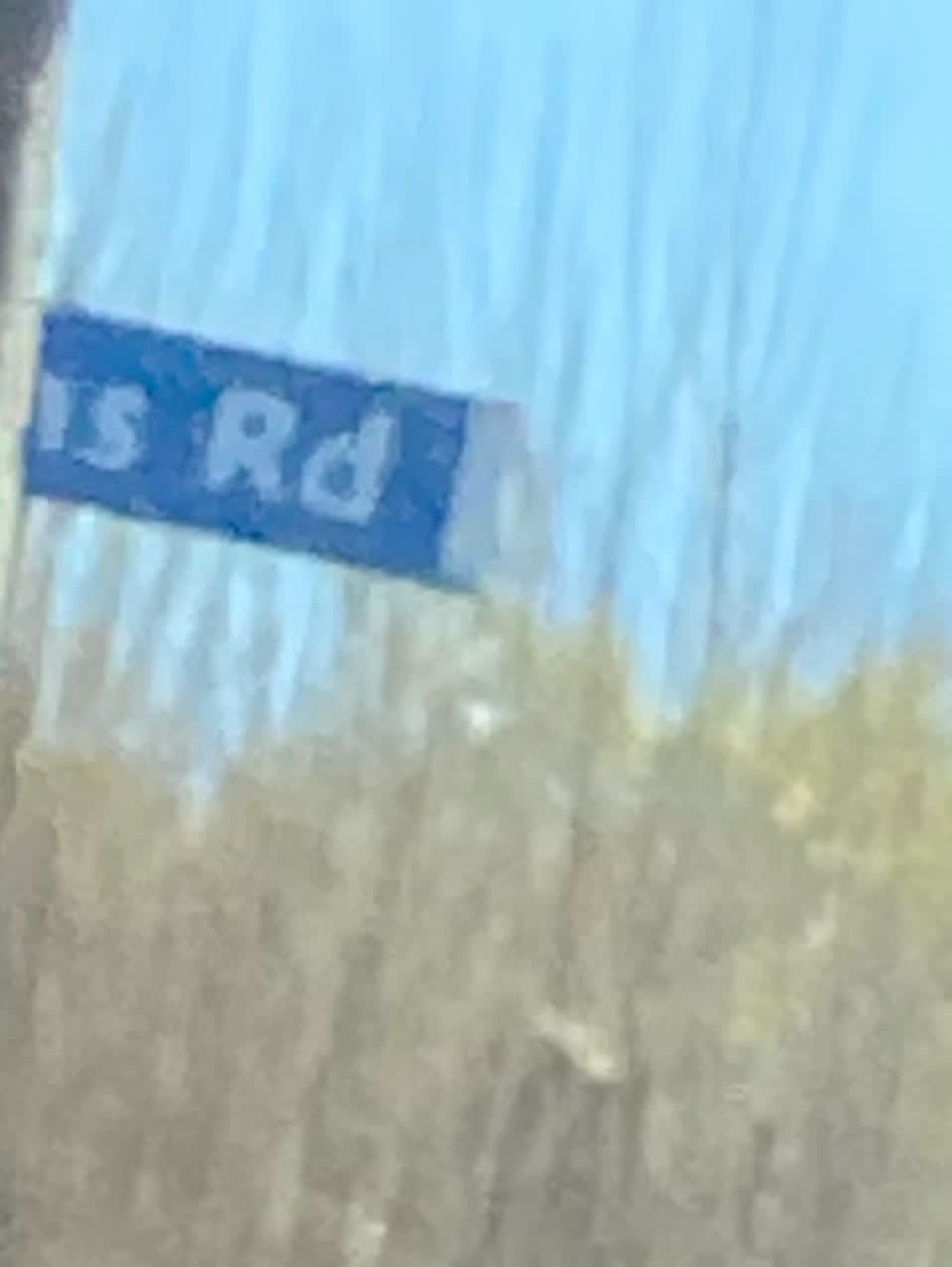 The photograph attached to this damaged street sign report