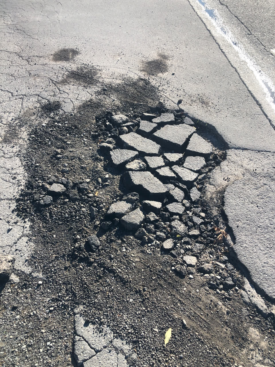 The photograph attached to this pavement - damaged report