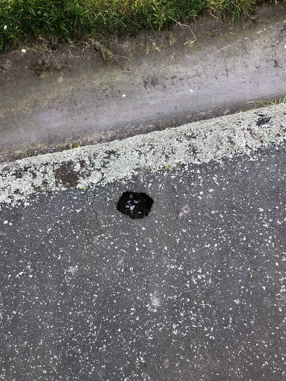 The photograph attached to this pavement - damaged report