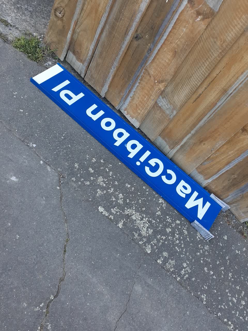 The photograph attached to this damaged street sign report