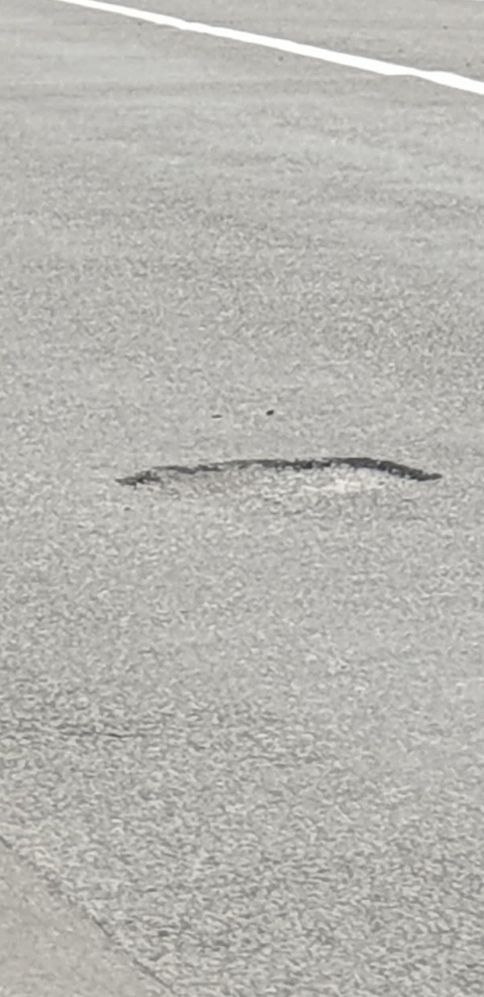 The photograph attached to this damaged road report