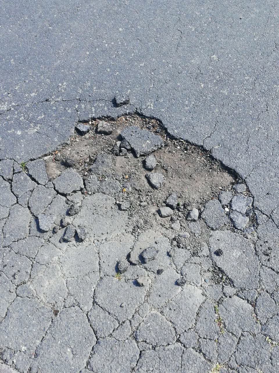 The photograph attached to this pavement - damaged report