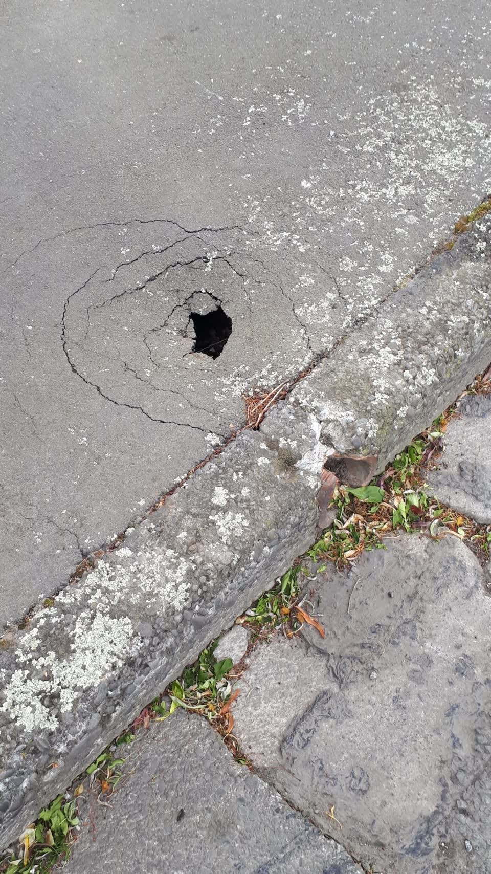 The photograph attached to this pavement - damaged report