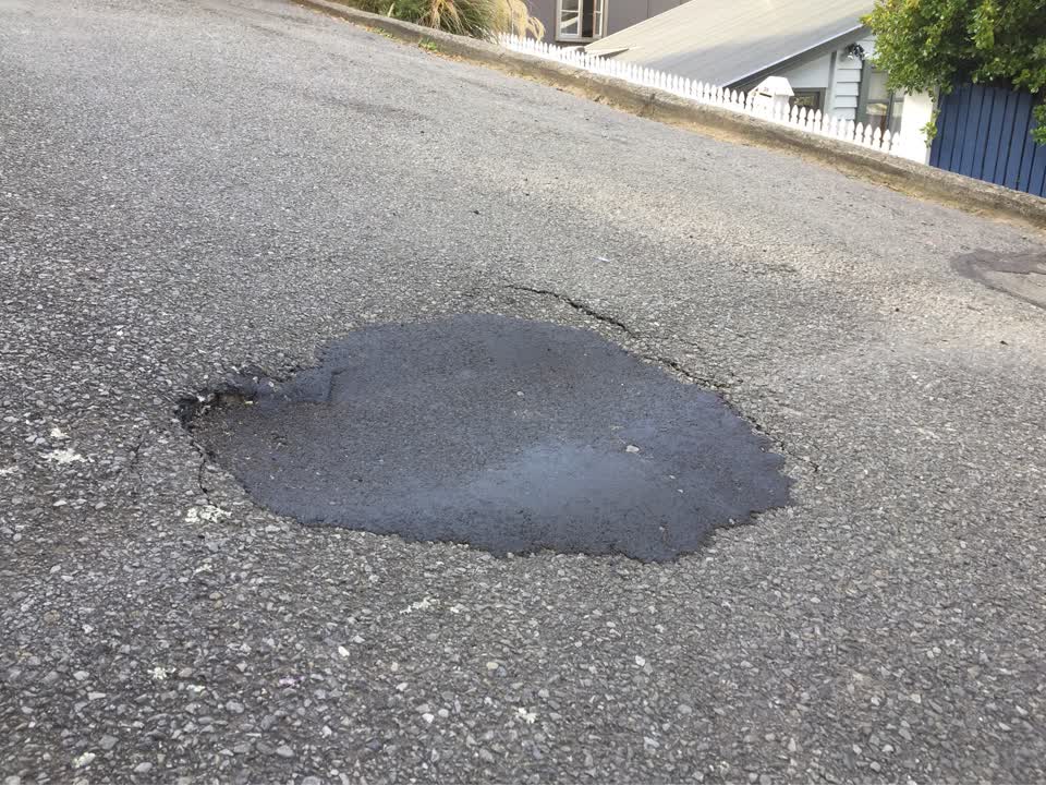 The photograph attached to this pavement - damaged report