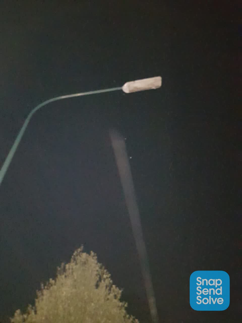 The photograph attached to this street light outage report