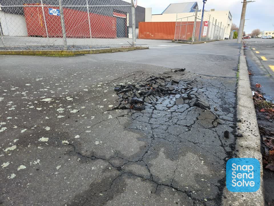 The photograph attached to this pavement - damaged report