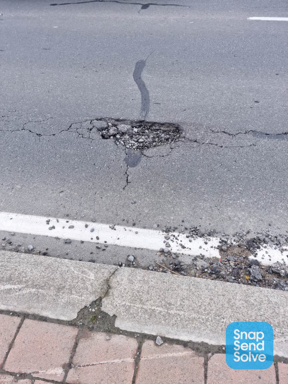 The photograph attached to this pothole report