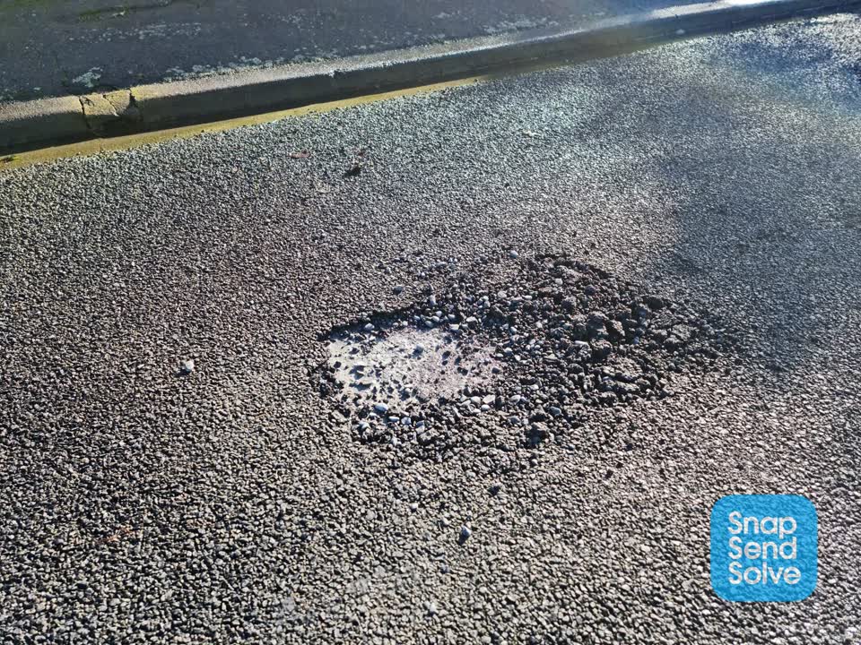 The photograph attached to this pothole report