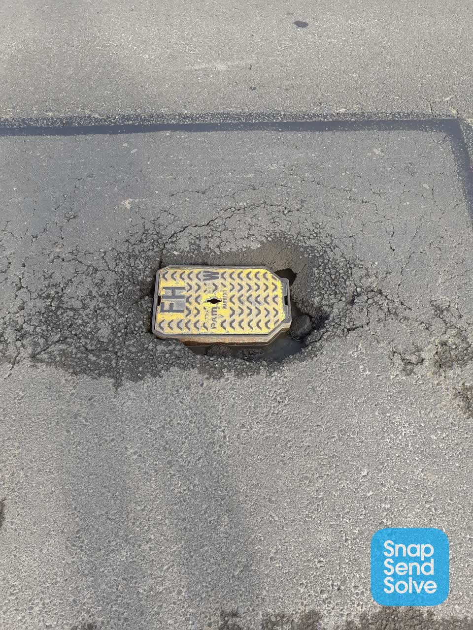 The photograph attached to this damaged road report