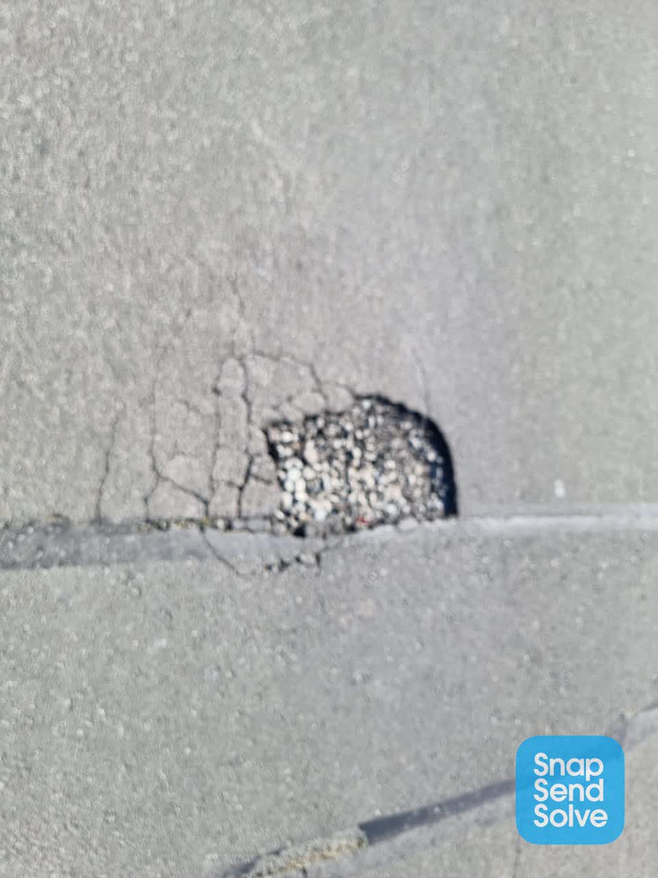 The photograph attached to this pothole report