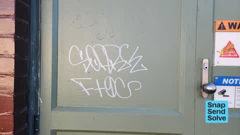 Graffiti on a fence, building or structure, a report photo