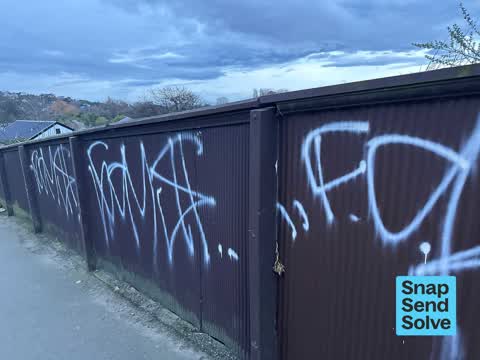 Graffiti on a fence, building or structure, a report photo