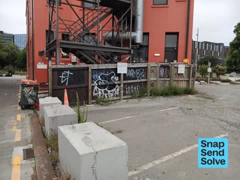 Graffiti on a fence, building or structure, a report photo