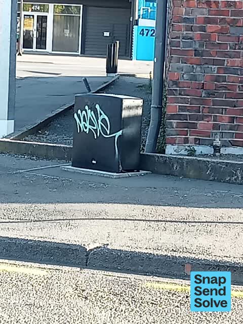 Graffiti on a traffic light pole or cabinet, or wa, a report photo