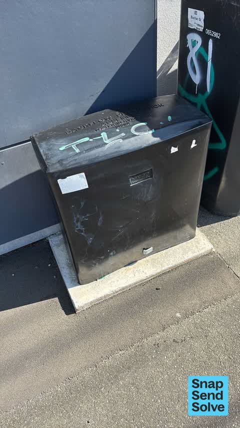 Graffiti on a traffic light pole or cabinet, or wa — a report photo