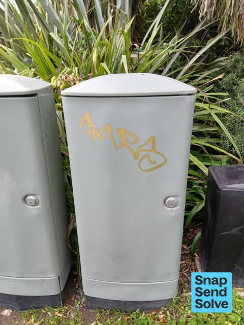 Graffiti on a traffic light pole or cabinet, or wa, a report photo