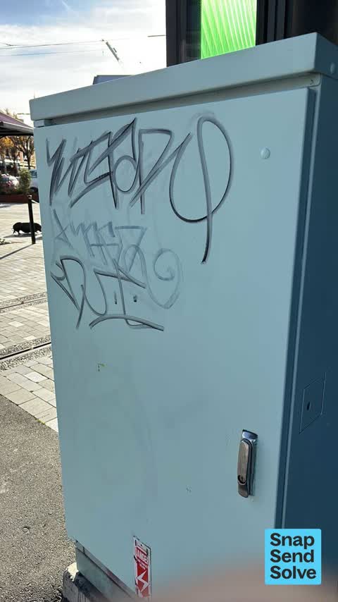 Graffiti on a traffic light pole or cabinet, or wa, a report photo