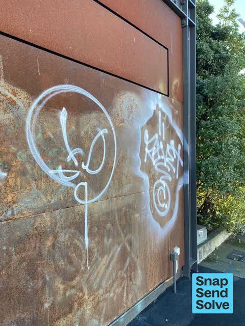 Graffiti on a fence, building or structure, a report photo