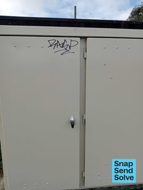 Graffiti on a traffic light pole or cabinet, or wa, a report photo