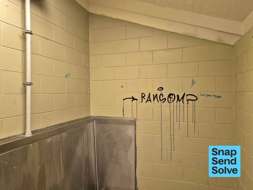 The photograph attached to this graffiti on a bus stop or public toilet report