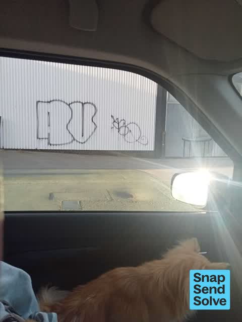 Graffiti on a fence, building or structure, a report photo