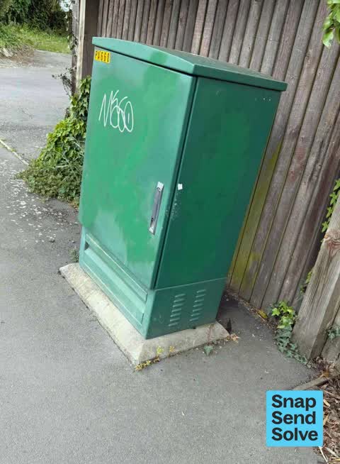 Graffiti on a traffic light pole or cabinet, or wa, a report photo