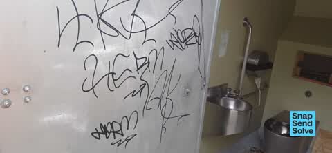 Graffiti on a bus stop or public toilet, a report photo