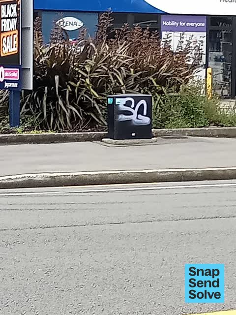 Graffiti on a traffic light pole or cabinet, or wa, a report photo