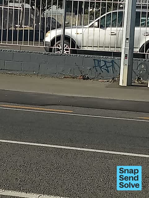 Graffiti on a fence, building or structure, a report photo