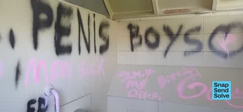 Graffiti on a bus stop or public toilet, a report photo