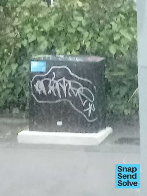 Graffiti on a traffic light pole or cabinet, or wa, a report photo