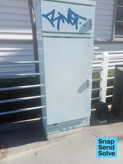 Graffiti on a traffic light pole or cabinet, or wa — a report photo
