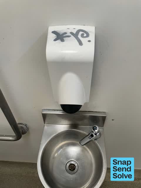 Graffiti on a bus stop or public toilet, a report photo