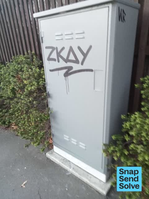 Graffiti on a traffic light pole or cabinet, or wa, a report photo