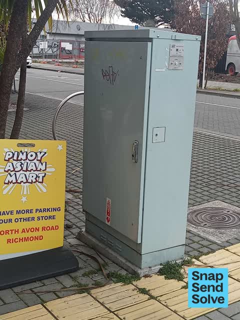 Graffiti on a traffic light pole or cabinet, or wa, a report photo