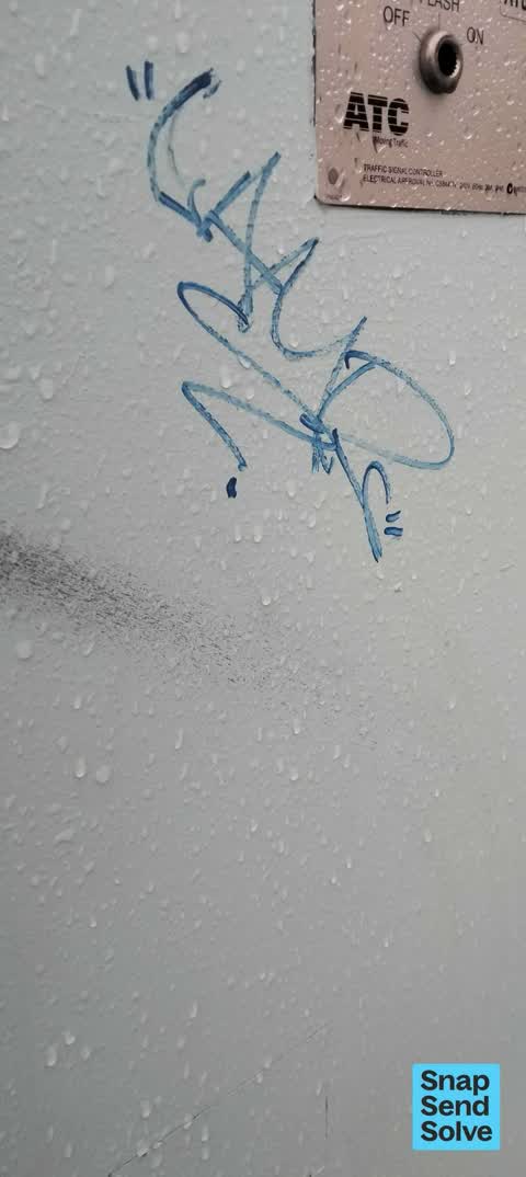 Graffiti on a traffic light pole or cabinet, or wa, a report photo
