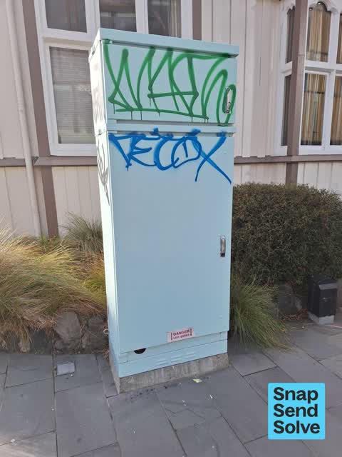 Graffiti on a traffic light pole or cabinet, or wa, a report photo