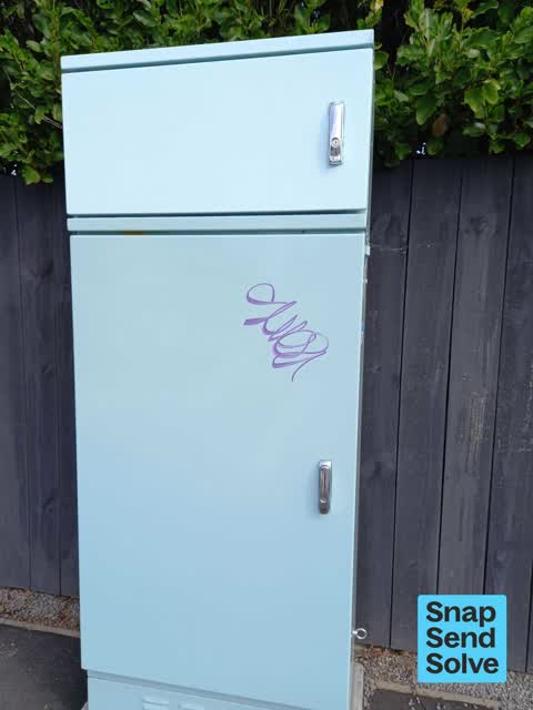 Graffiti on a traffic light pole or cabinet, or wa — a report photo