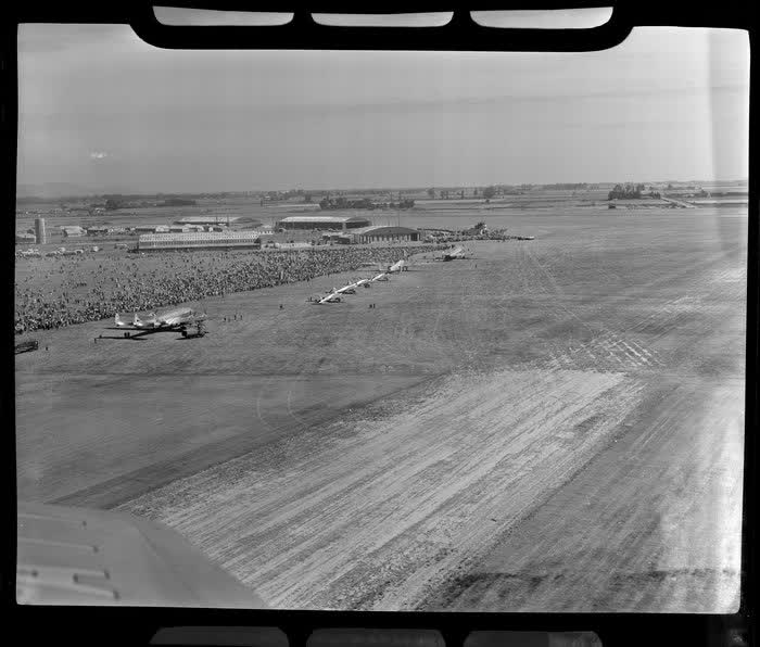 Aerial view of aircraft and spectators on airfield, dedication of Harewood Airport, Christchurch, 1950