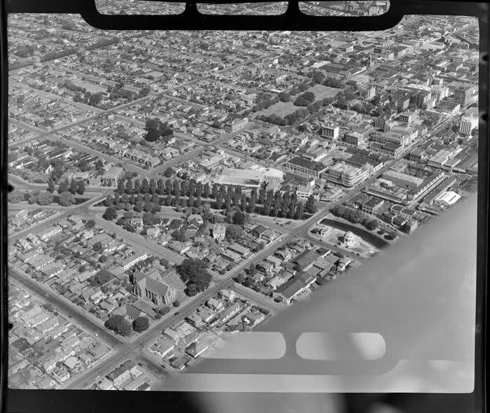A view of Manchester Street, going towards Christchurch City, including Avon River in the foreground, 1950