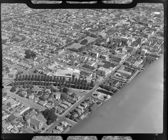 A view of Manchester Street, going towards Christchurch City, including Avon river in the foreground, 1950