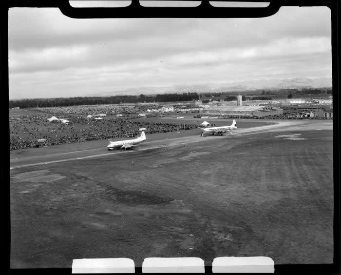 Harewood Airport, Christchurch, 1953 London-Christchurch Air Race, showing two aircrafts BEA Viscount (front) and KLM DC6 (rear) and large crowd of spectators, 1953