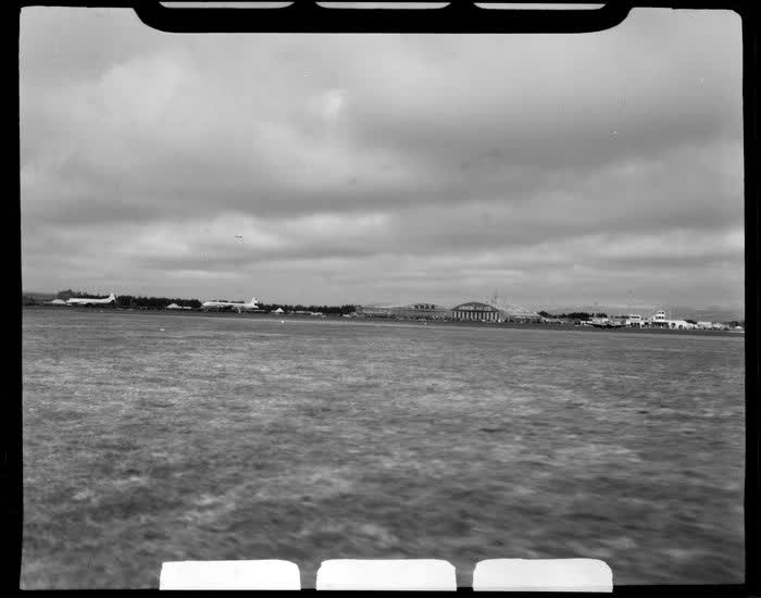 Harewood Airport, Christchurch, during the 1953 London-Christchurch Air Race, showing planes in the distance, 1953